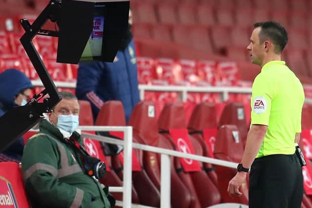 Monitoring: Referee Stuart Attwell checks VAR after the overturning of a  penalty decision at The Emirates Stadium.