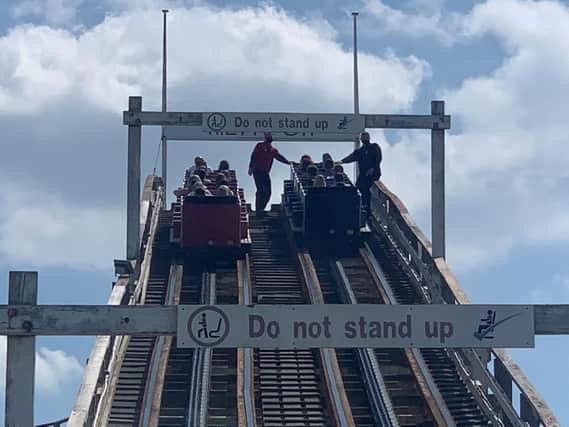 Visitors are helped down from the Grand National rollercoaster ride at Blackpool Pleasure Beach.