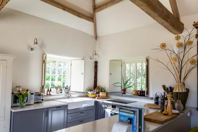 Old meets new in the kitchen, which features original beams and trusses