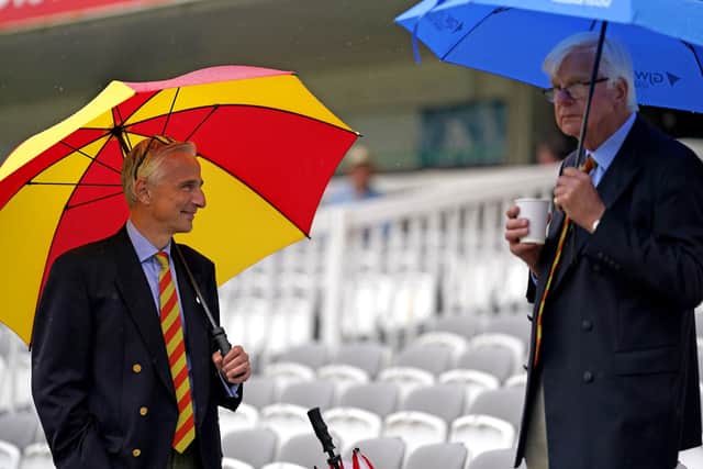 No play: Spectators shield themselves from the rain ahead of day three of the first  Test match at Lord's.