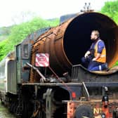 Apprentice Mark Readman checking out the boiler on the rusting Dame Vera Lynn  parked up in a siding near the sheds at Grosmont on the North York Moors Railway