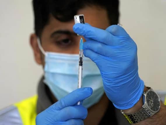 An NHS worker prepares a dose of a vaccine in Bolton