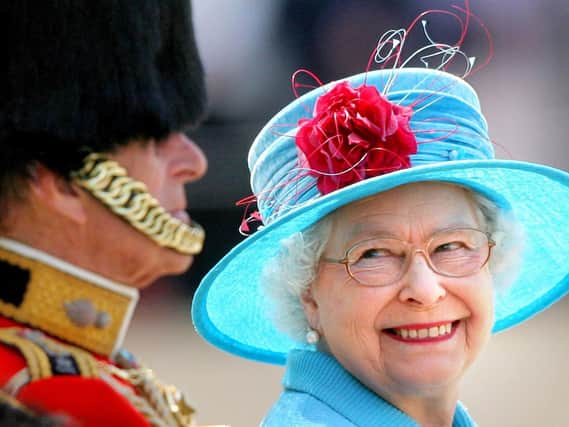Queen Elizabeth II smiling with the Duke of Edinburgh during the annual Trooping the Colour parade in 2009. This year's Trooping the Colour is taking place two days after what would have been the Duke's 100th birthday.