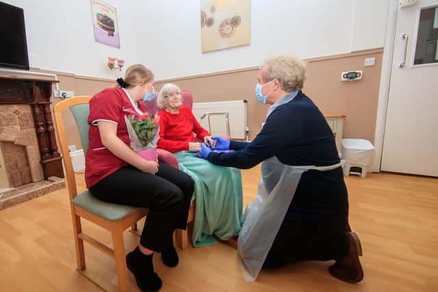 Mike Padgham (right) visits his 93-year-old mother Phyllis Padgham (centre) with Activities Assistant Charlotte Henderson (left)  at St Cecilia's Nursing Home in Scarborough, North Yorkshire.