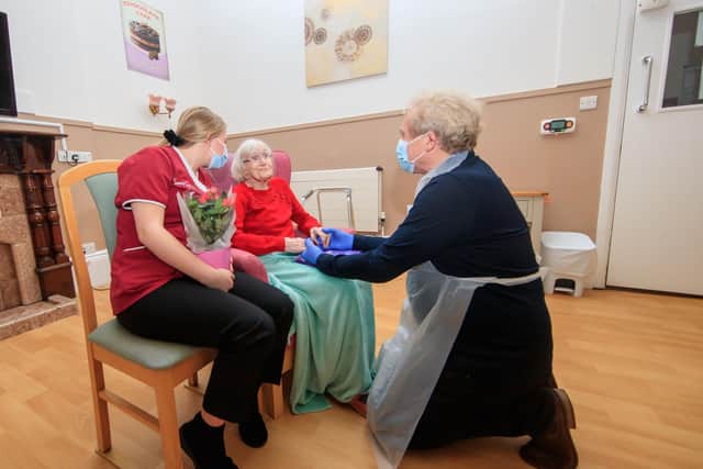 Mike Padgham (right) visits his 93-year-old mother Phyllis Padgham (centre) with Activities Assistant Charlotte Henderson (left)  at St Cecilia's Nursing Home in Scarborough, North Yorkshire.