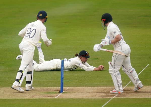 Out: New Zealand's Henry Nicholls, right is caught by England's Rory Burns off the bowling of Joe Root.