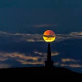 A partial lunar eclipse rising over Stoodley Pike, Todmorden in 2019