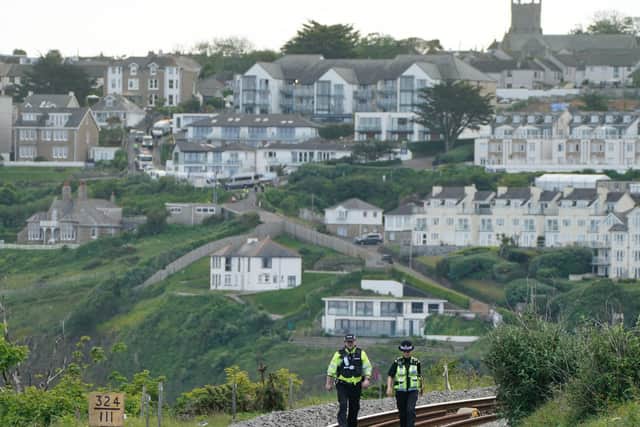 Police officers patrol the railway tracks into Carbis Bay, Cornwall, ahead of the G7 summit in Cornwall.