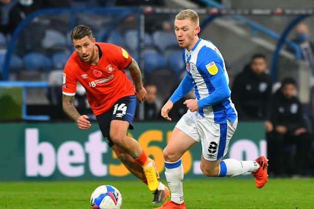 Lewis O'Brien, of Huddersfield Town, races for the ball alongside Luton's George Moncur. Picture: James Hardisty