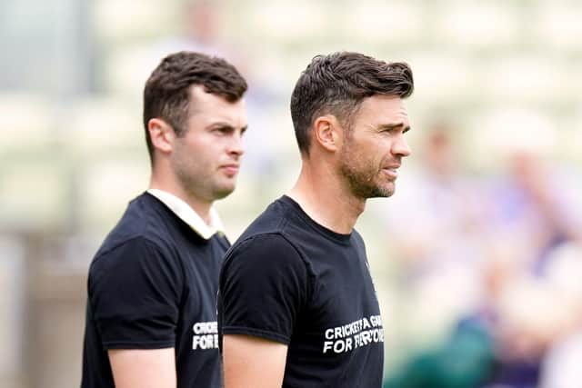 Record-breaker: James Anderson, right, lines up wearing a t-shirts campaigning against various discriminations.