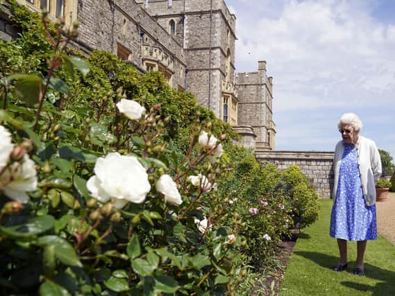Queen Elizabeth II views a border in the gardens of Windsor Castle, in Berkshire