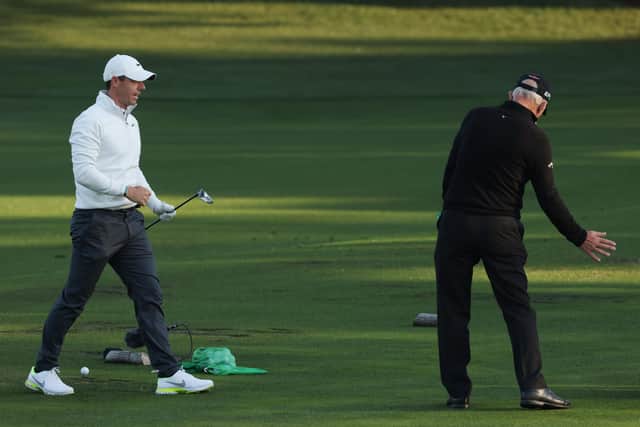 Rory McIlroy of Northern Ireland works with coach Pete Cowen on the range during a practice round prior to the Masters at Augusta National. (Picture: Kevin C. Cox/Getty Images)