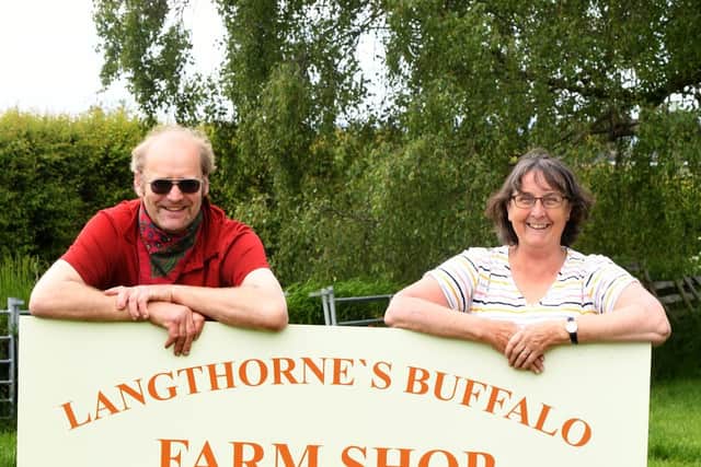 Paul and Kate Langthorne  with their new farm shop sign at Brompton