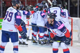 MAGIC MOMENT: GB's players celebrate their historic win over Belarus in Riga, while defenceman Davey Phillips takes it all in. Picture courtesy of Dean Woolley.