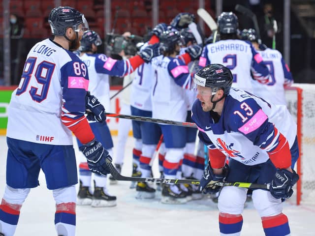 MAGIC MOMENT: GB's players celebrate their historic win over Belarus in Riga, while defenceman Davey Phillips takes it all in. Picture courtesy of Dean Woolley.