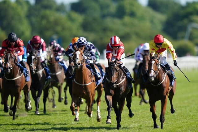 La Trinidad and Jason Hart (2nd right, red and white) coming home to win the Ice Co Supporting Macmillan Handicap at York Racecourse.