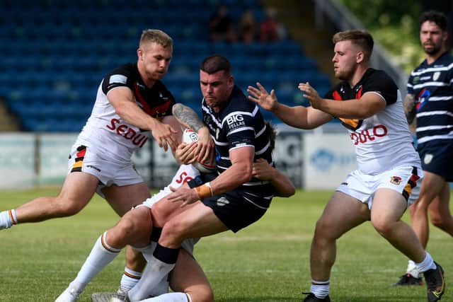 Featherstone Rovers' Darcy Lussick is held up by Bradford Bulls' opponents. Picture by Simon Hulme