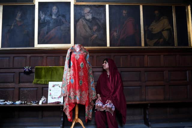 Zanib Rasool, pictured with a wedding dress on display at the exhibition. (Simon Hulme).