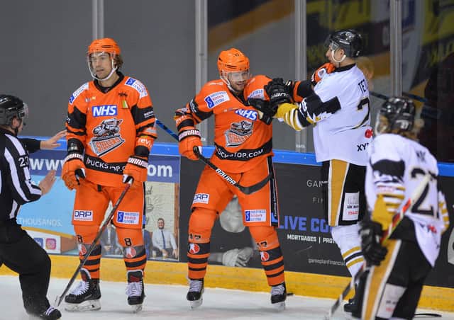 WE'LL MEET AGAIN:  Adrian Saxrud Danielsen, right, gets to grips with a Nottingham Panthers opponent during the Elite Series - something he'll be able to do more of next season in the Elite League. Picture: Dean Woolley.