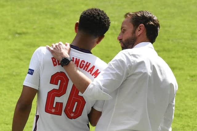 Bright hope: England's manager Gareth Southgate, right, talks with England's youngest player Jude Bellingham.