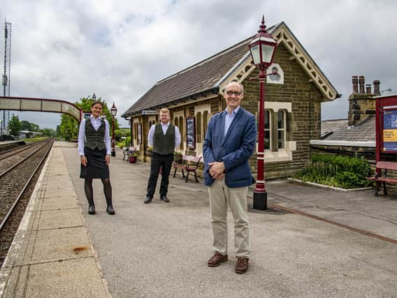 Adrian Quine, right, with Emilia Steven and Alan Collinson from Rail Charter Services Ltd at Settle railway station.Picture by Tony Johnson.