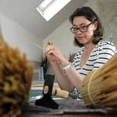 Delphine Robins doing some straw marquetry at her home in Scarborough