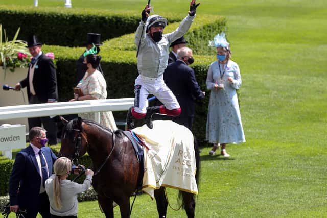 Jockey Frankie Dettori performs his trademark flying dismount as he celebrates winning the Queen Anne Stakes on Palace Pier.