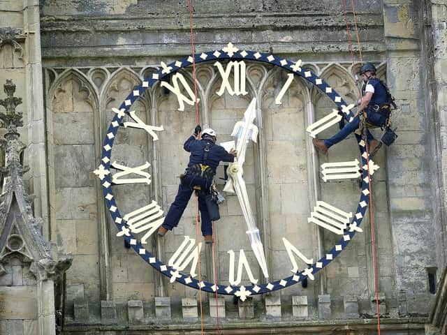Beverley Minster has it's clock hands returned to the clock face after restoration work by expert workers Stuart Morrison and Stephen Davies. Photo credit: Richard Ponter/JPIMedia