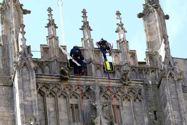 A long-awaited facelift has been given to the clock of one of the most spectacular places of worship in the region as workers had to abseil down historic building to finish the job. Photo credit: Richard Ponter/JPIMedia