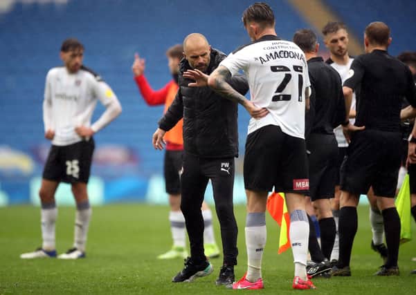 Cost of the drop: Rotherham United manager Paul Warne and Angus MacDonald after their relegation is confirmed at the Cardiff City Stadium. Picture: PA