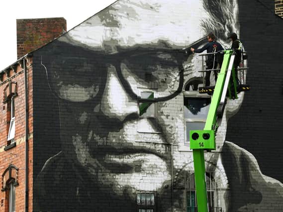 Artist Irek Jasutowicz puts the finishing touches to the mural of Leeds United head coach Marcelo Bielsa on Hyde Park corner in Leeds in September 2020.
Picture: Jonathan Gawthorpe
