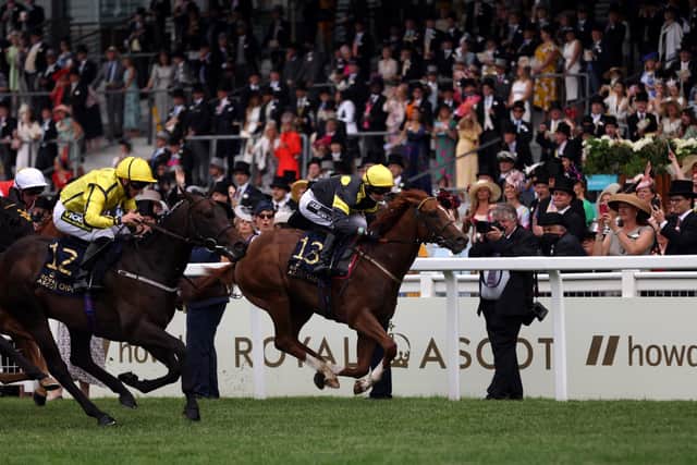 Perfect Power ridden by jockey Paul Hanagan (far side yellow silks) on their way to winning the Norfolk Stakes during day three of Royal Ascot.