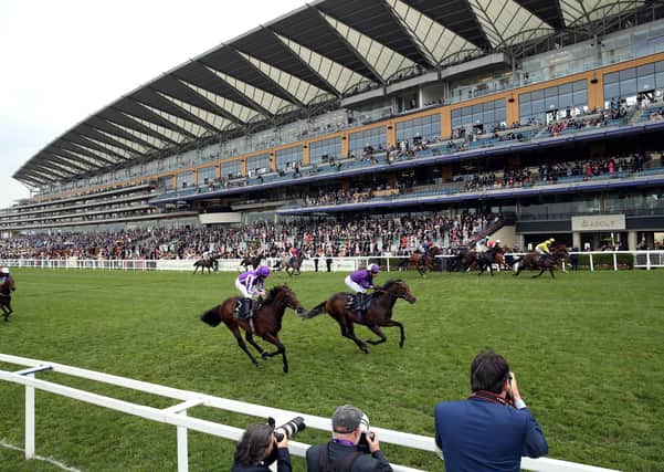 Perfect Power ridden by jockey Paul Hanagan (far side yellow silks) on their way to winning the Norfolk Stakes during day three of Royal Ascot at Ascot Racecourse. (Picture: PA)