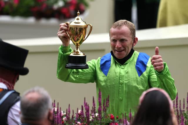 Joe Fanning celebrates with the trophy after winning the Gold Cup on Subjectivist during day three of Royal Ascot at Ascot Racecourse.