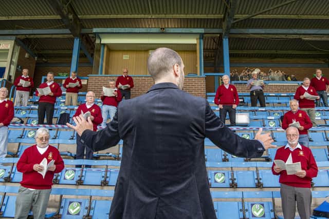 Featherstone Male Voice Choir socially distanced as they gather in the stand at a Covid secure Featherstone Rovers Rugby League Club  to practice together and not over Zoom sessions. Picture Tony Johnson