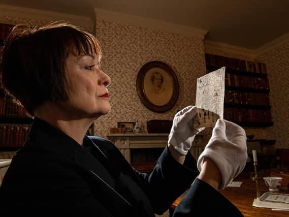 Ann Dinsdale, the Parsonage museum’s principal curator, looking through poem manuscripts of Emily Bronte in the dining room..  Picture Bruce Rollinson