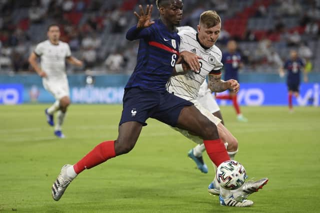 France's Paul Pogba and Germany's Toni Kroos challenge for the ball in Munich. Picture: Matthias Hangst/Pool via AP