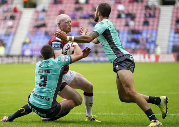 Wigan Warriors' Liam Farrell is tackled by Hull Kingston Rovers' Ben Crooks (right) and Greg Minikin (left) (Picture: PA)