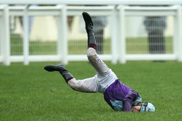 Jockey Oisin Murphy jumps off his horse and falls over after winning the Coronation Stakes on Alcohol Free during day four of Royal Ascot at Ascot Racecourse.