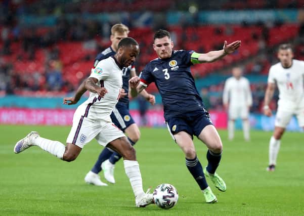 England's Raheem Sterling (left) and Scotland's Andrew Robertson battle for the ball at Wembley Stadium on Friday night. Picture: Nick Potts/PA