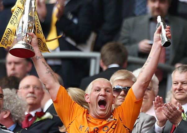 Glory days: Hull City's Dean Windass lifts the Championship play-off trophy after the 2008 final at Wembley Stadium. He later battled alcohol and depression. Picure: PA