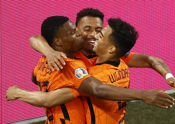 Back in business: Netherlands' Denzel Dumfries, left, celebrates with his teammates after scoring against Austria. Picture: AP