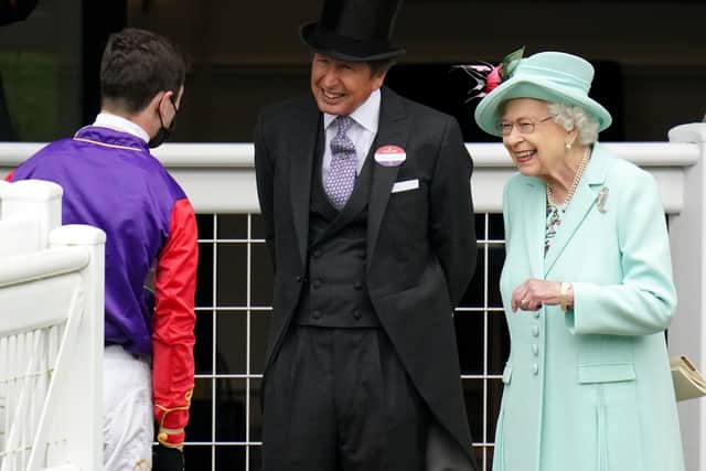 Queen Elizabeth II and racing manager John Warren (centre) speak with jockey Oisin Murphy during day five of Royal Ascot