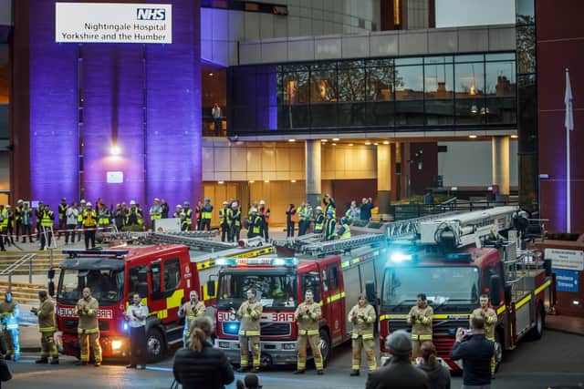 Members of the fire brigade, construction workers and members of the public, clapping outside the Nightingale Hospital at the Harrogate Convention Centre in Harrogate, to salute local heroes during a nationwide Clap for Carers NHS initiative to applaud NHS workers fighting the coronavirus pandemic.