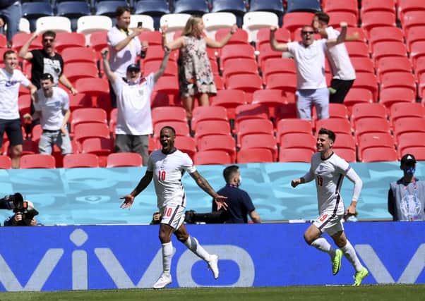 PLAY YOUR PART: England fans cheer as England's Raheem Sterling, left, celebrates with Mason Mount after scoring what proved to be the winning goal against Croatia at Euro 2020 at Wembley. Picture: Laurence Griffiths/AP.