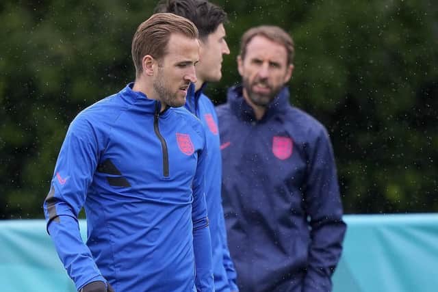 England's Harry Kane, left, Harry Maguire, centre, and England's manager Gareth Southgate, pictured during a team training session at Tottenham Hotspur's training ground on Monday. Picture: AP/Frank Augstein.