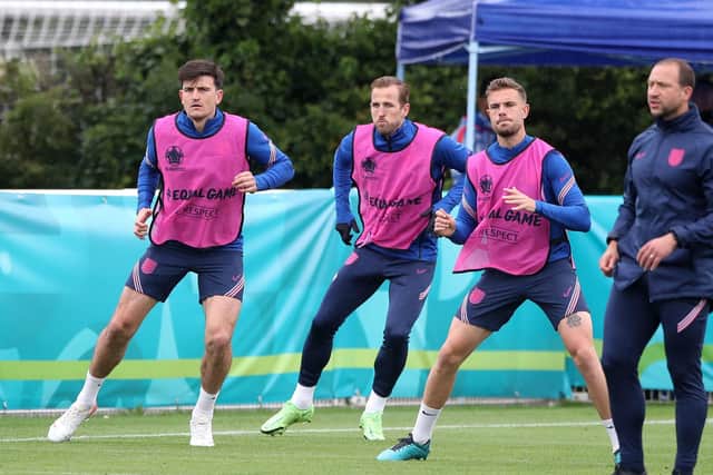 GETTING THERE: England's Harry Maguire (left), Harry Kane (centre) and Jordan Henderson during a training session at Hotspur Way Training Ground. Picture: Nick Potts/PA