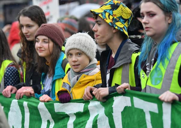 Environmental activist Greta Thunberg (centre) marches during a Youth Strike 4 Climate protest in Bristol.