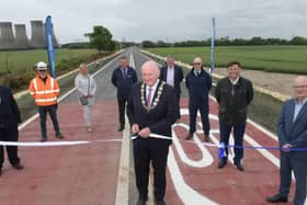 North Yorkshire County Council chair Coun Stuart Martin cuts the ribbon at the reopening of the A19 at Chapel Haddlesey with representatives of the County Council’s highways team, Balfour Beatty, the LEP and consultants WSP