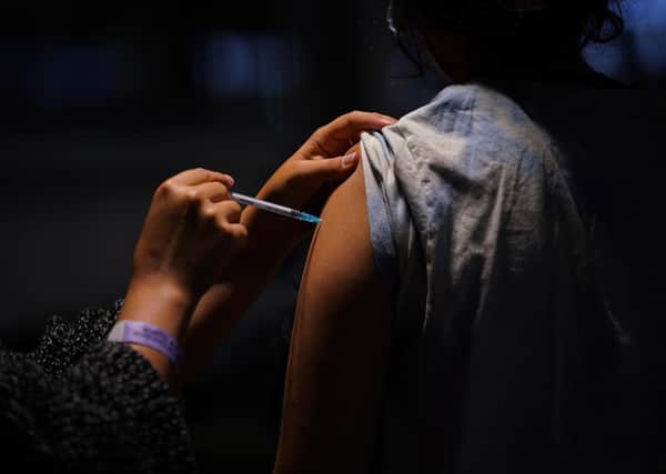 A woman receives a Pfizer BioNTech COVID-19 vaccine at an NHS Vaccination Clinic at Tottenham Hotspur's stadium in north London. The NHS is braced for high demand as anyone in England over the age of 18 can now book a Covid-19 vaccination jab.Picture: Yui Mok/PA Wire